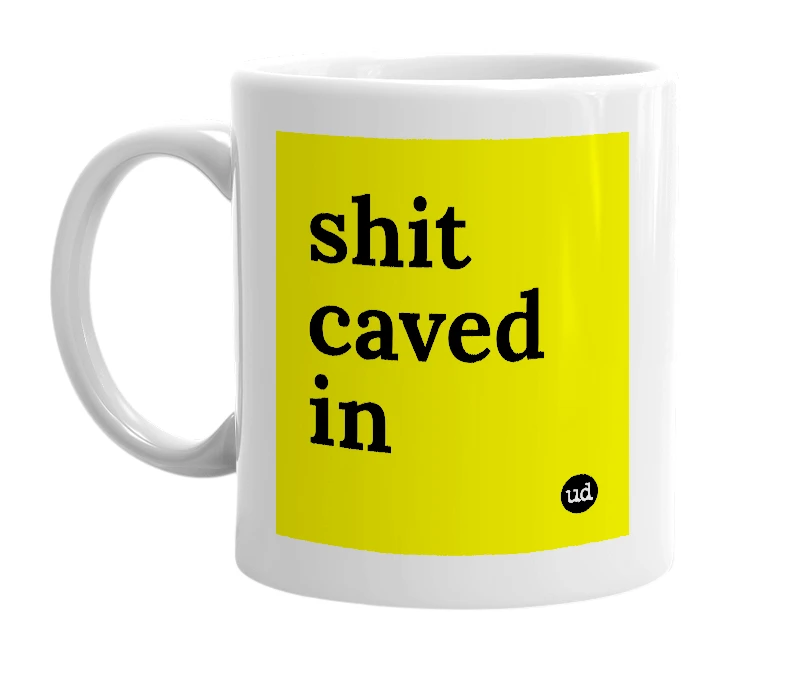 White mug with 'shit caved in' in bold black letters