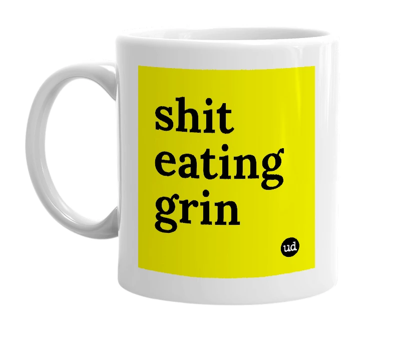 White mug with 'shit eating grin' in bold black letters