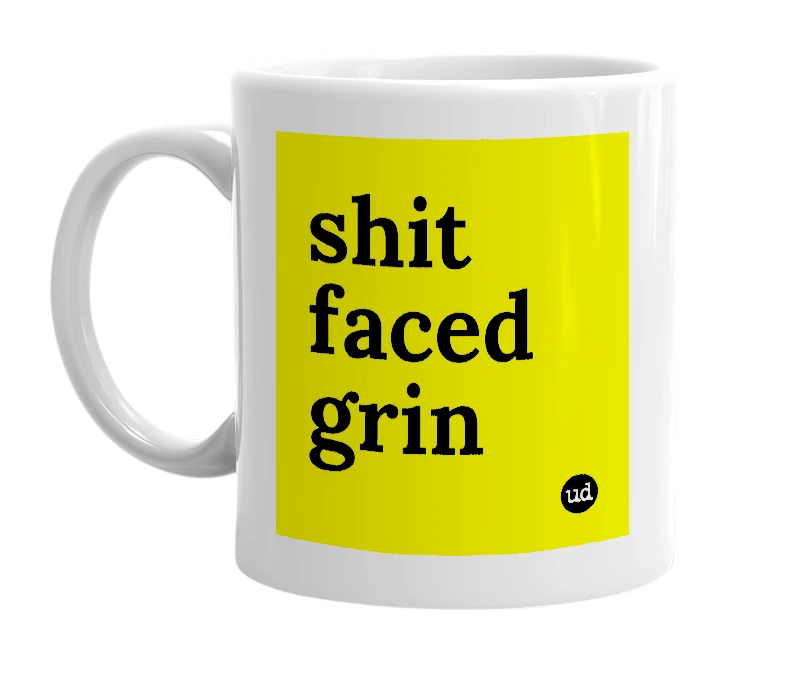 White mug with 'shit faced grin' in bold black letters