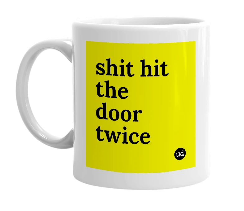 White mug with 'shit hit the door twice' in bold black letters