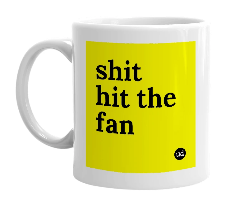 White mug with 'shit hit the fan' in bold black letters