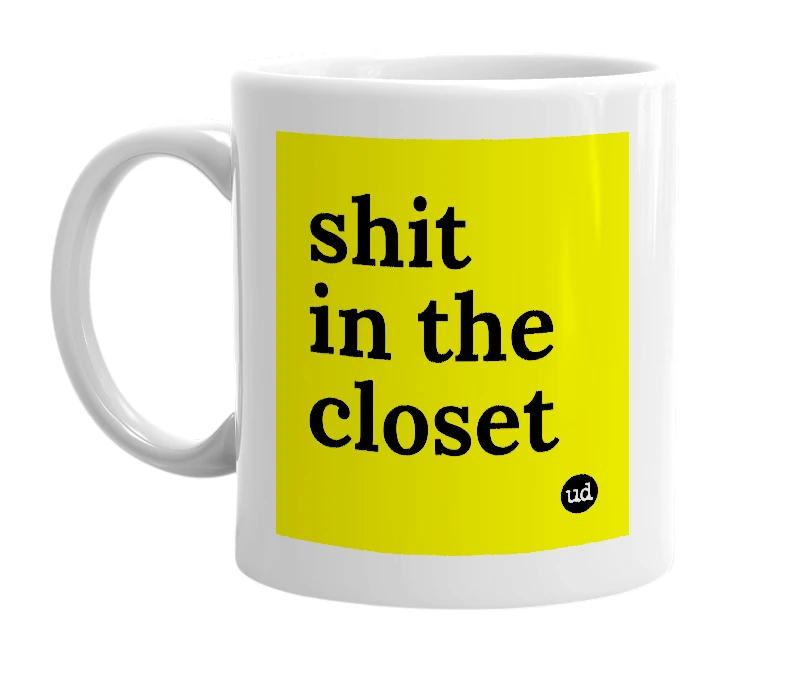 White mug with 'shit in the closet' in bold black letters