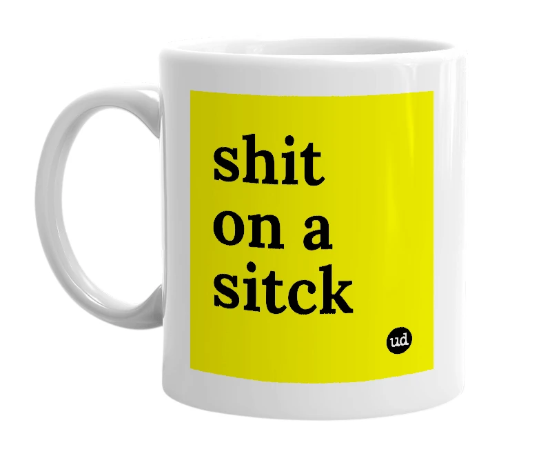 White mug with 'shit on a sitck' in bold black letters