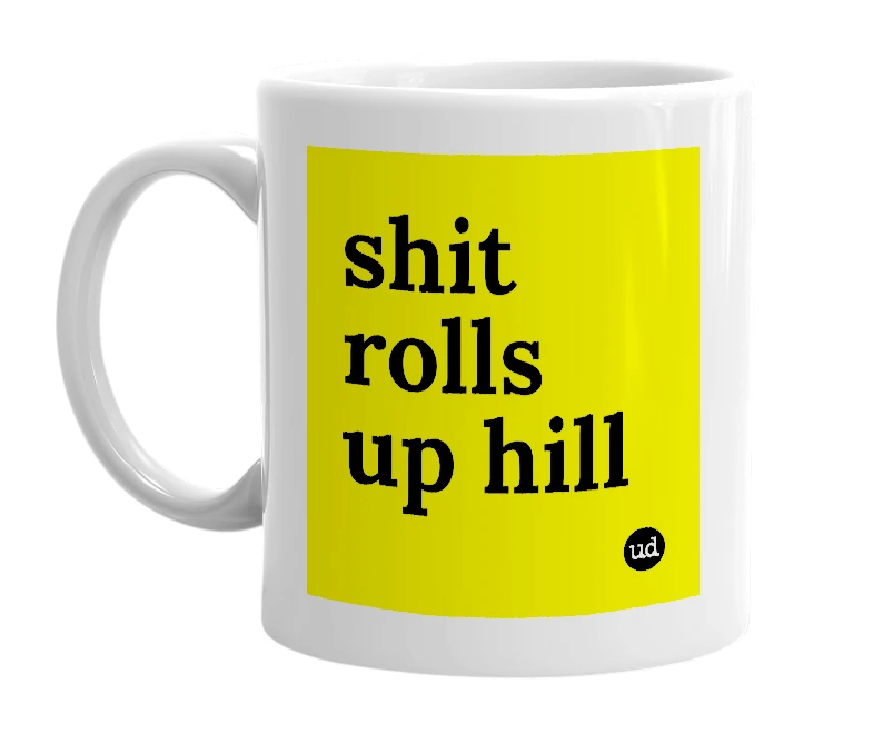 White mug with 'shit rolls up hill' in bold black letters