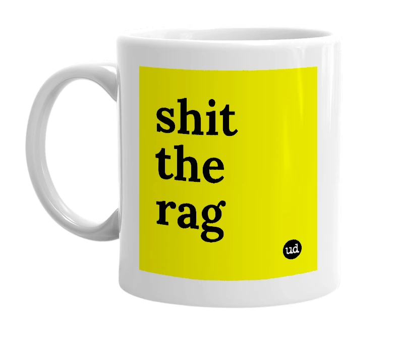 White mug with 'shit the rag' in bold black letters