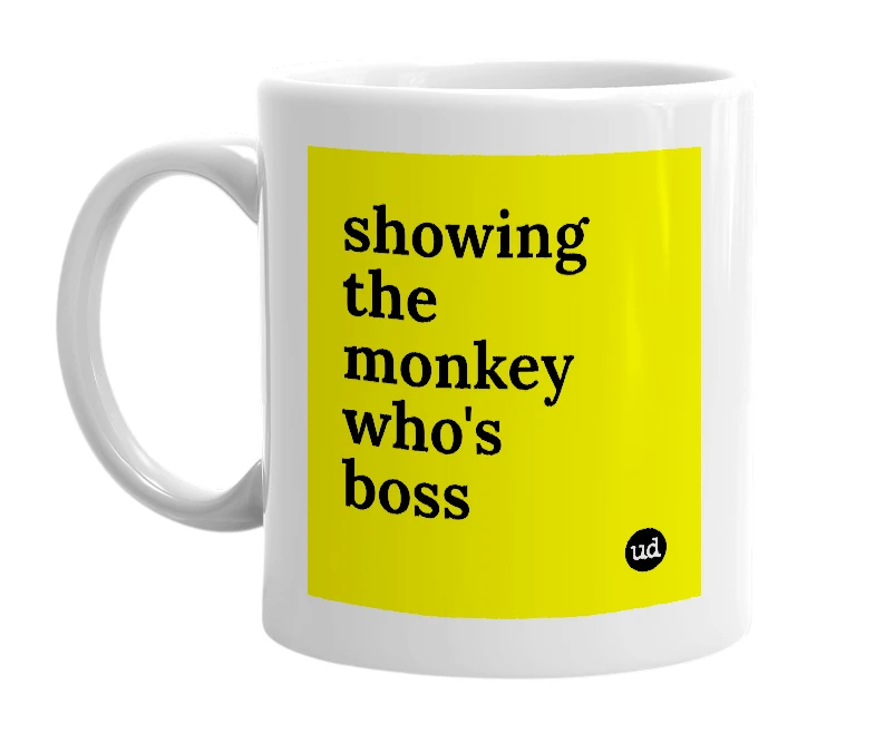 White mug with 'showing the monkey who's boss' in bold black letters