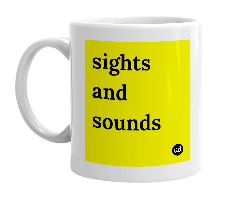 White mug with 'sights and sounds' in bold black letters
