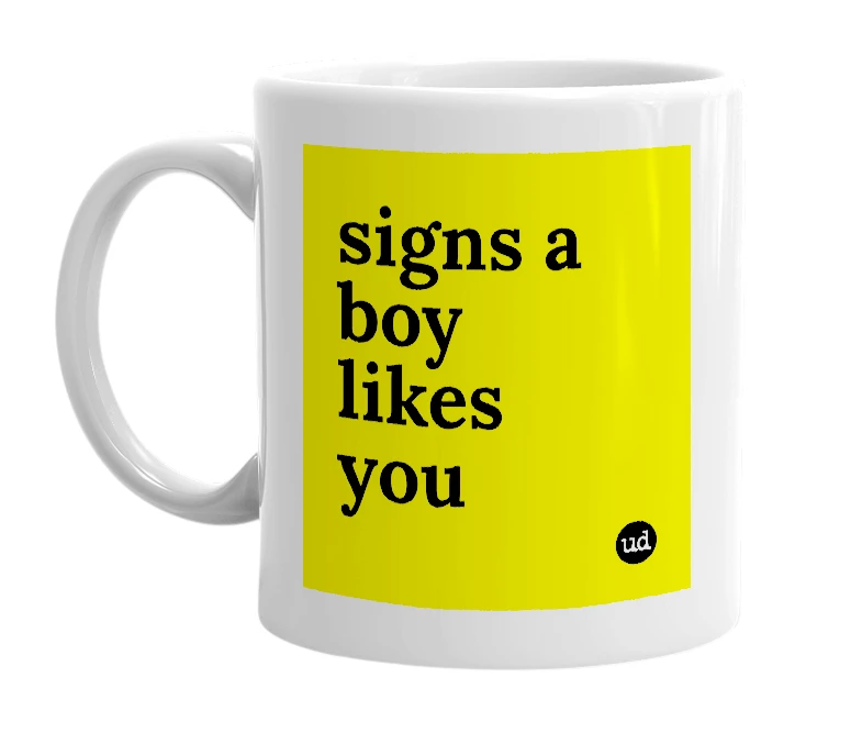 White mug with 'signs a boy likes you' in bold black letters