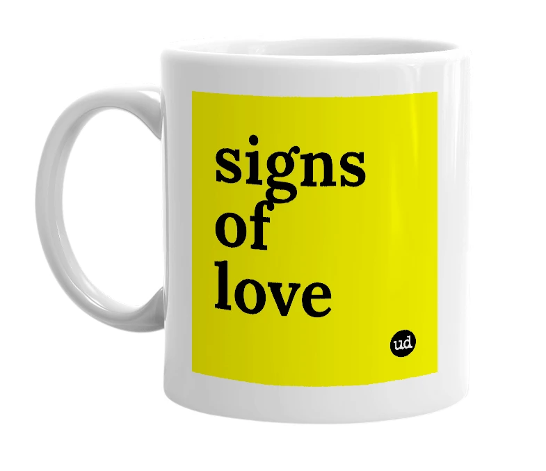 White mug with 'signs of love' in bold black letters