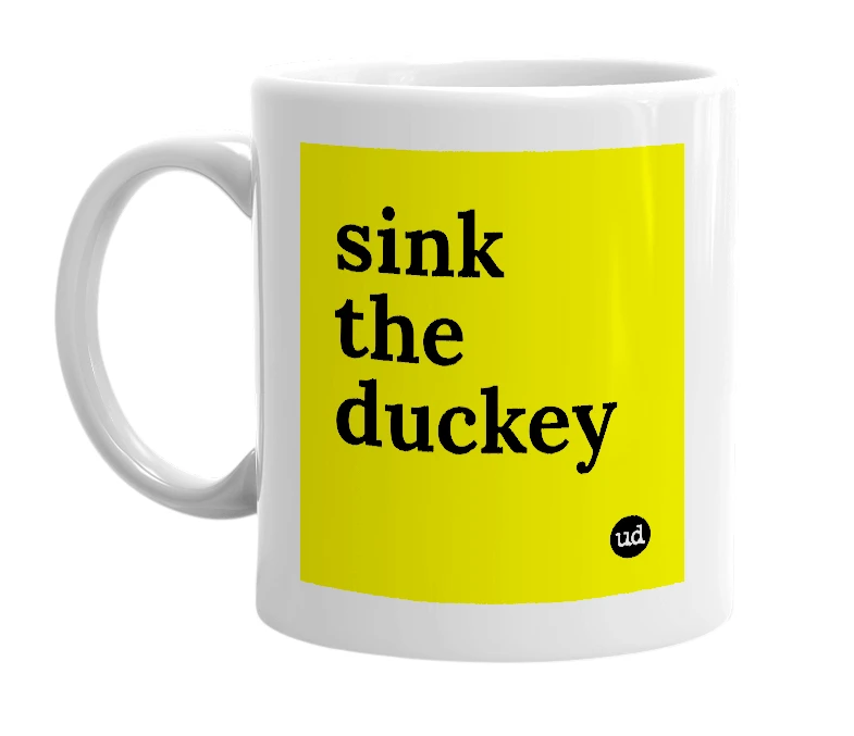 White mug with 'sink the duckey' in bold black letters