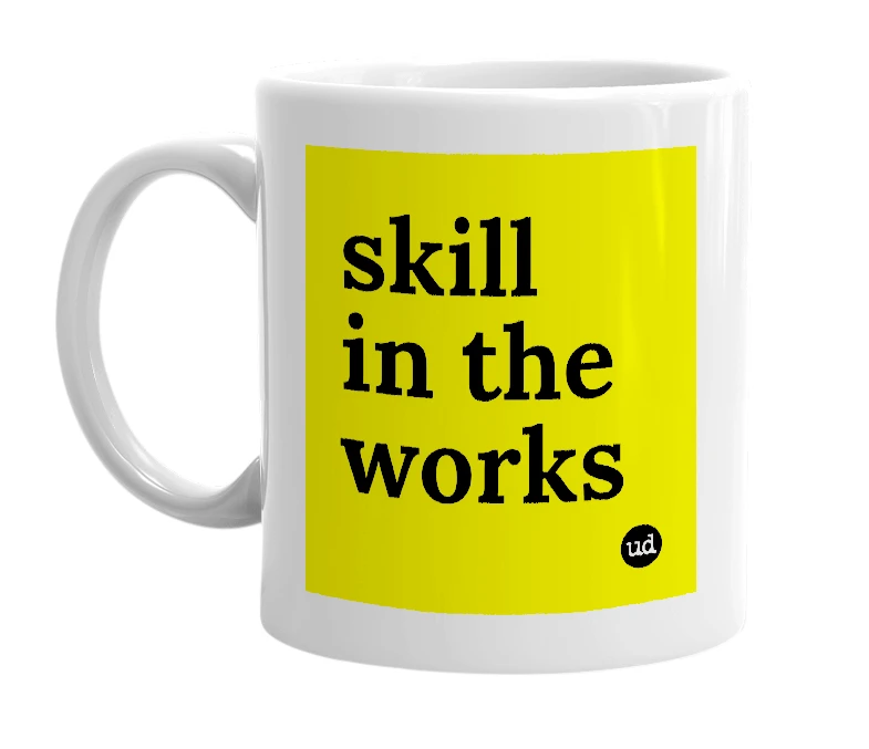 White mug with 'skill in the works' in bold black letters