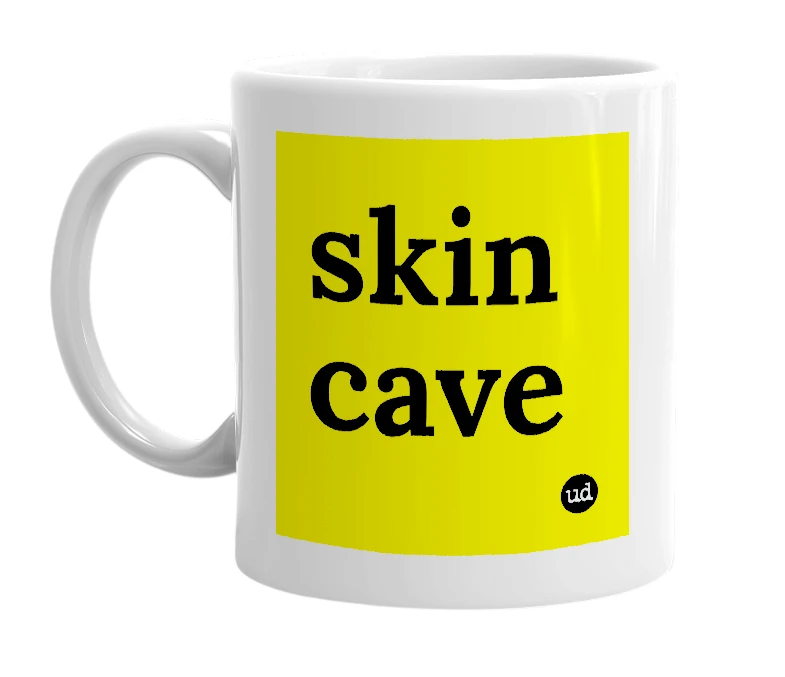 White mug with 'skin cave' in bold black letters