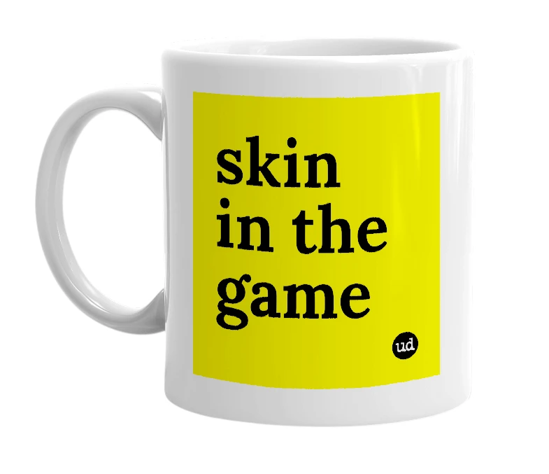 White mug with 'skin in the game' in bold black letters