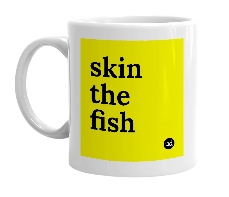 White mug with 'skin the fish' in bold black letters