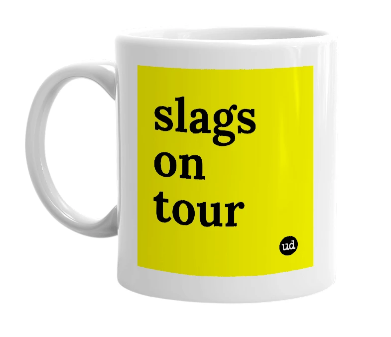 White mug with 'slags on tour' in bold black letters