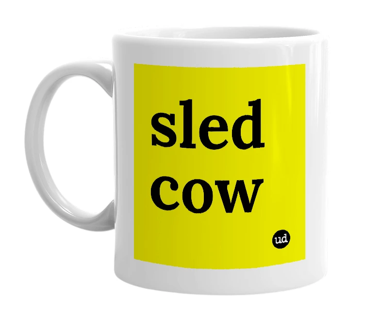 White mug with 'sled cow' in bold black letters