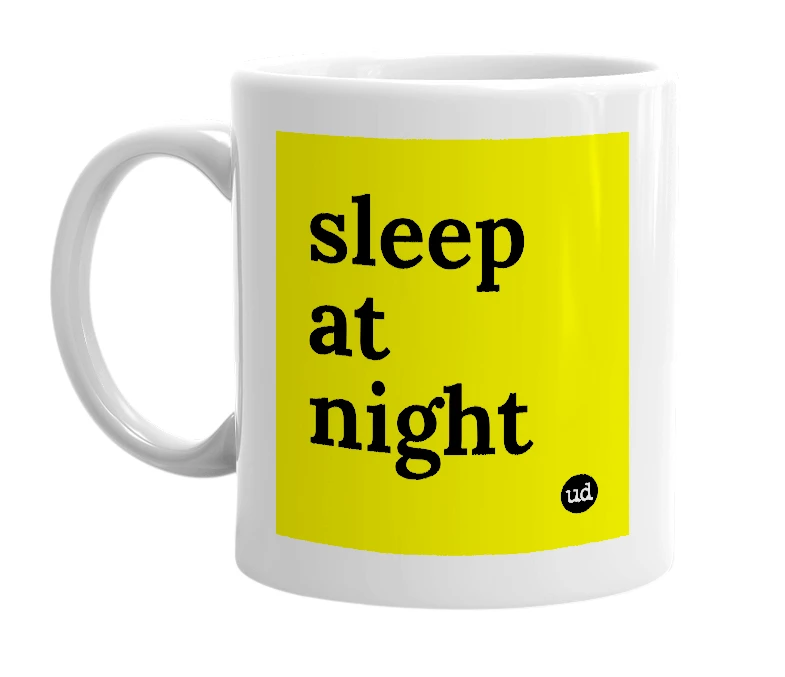 White mug with 'sleep at night' in bold black letters