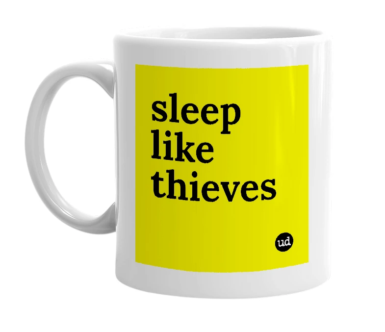 White mug with 'sleep like thieves' in bold black letters