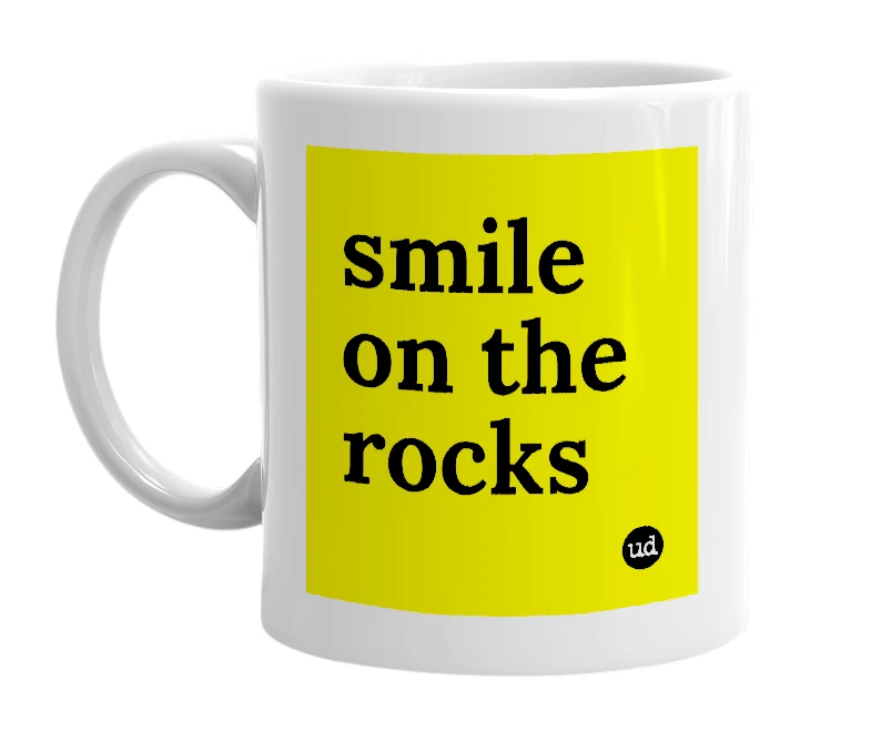 White mug with 'smile on the rocks' in bold black letters