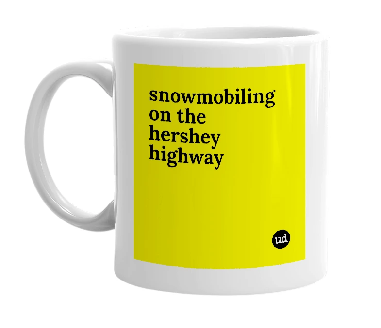 White mug with 'snowmobiling on the hershey highway' in bold black letters
