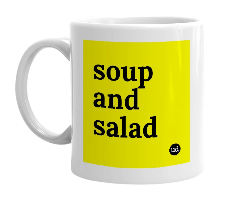 White mug with 'soup and salad' in bold black letters