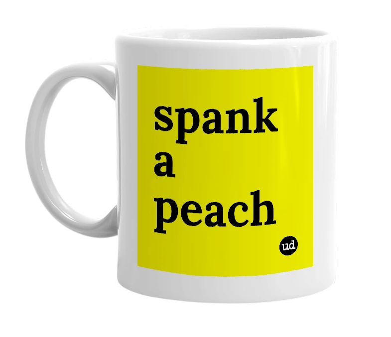White mug with 'spank a peach' in bold black letters