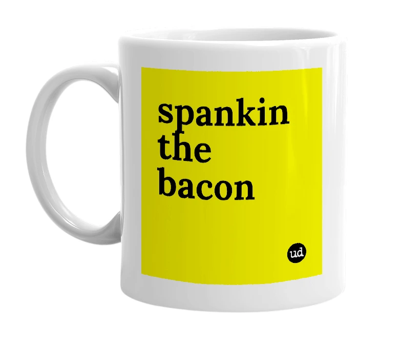 White mug with 'spankin the bacon' in bold black letters