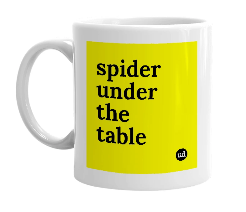 White mug with 'spider under the table' in bold black letters