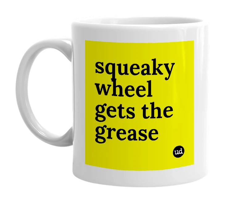 White mug with 'squeaky wheel gets the grease' in bold black letters