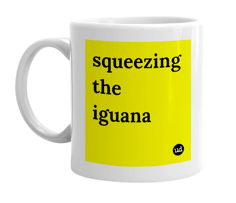 White mug with 'squeezing the iguana' in bold black letters