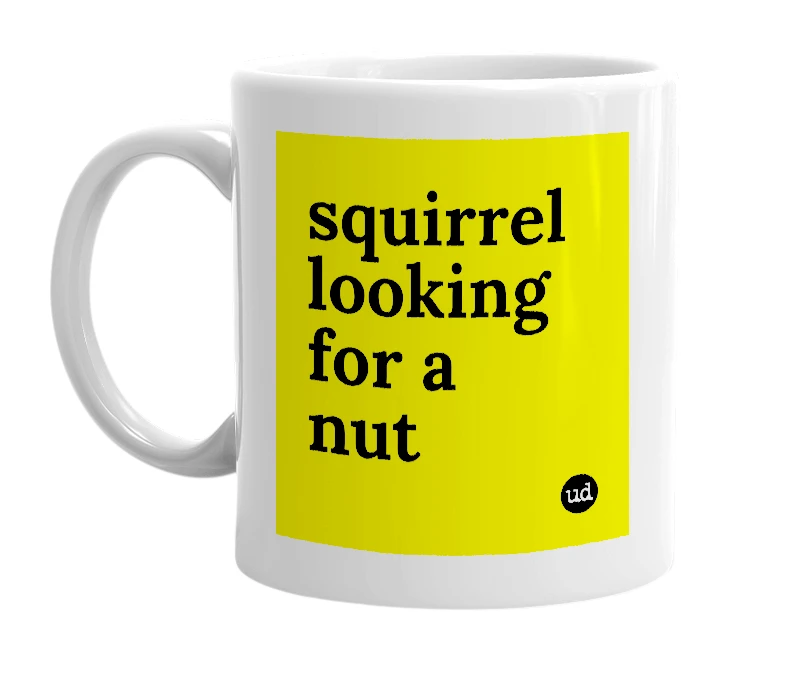 White mug with 'squirrel looking for a nut' in bold black letters