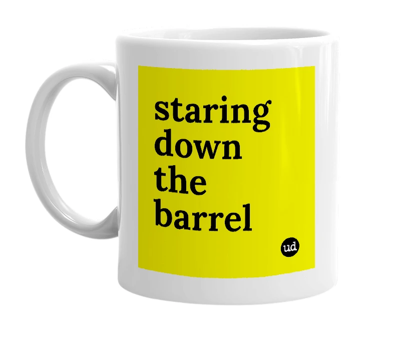 White mug with 'staring down the barrel' in bold black letters