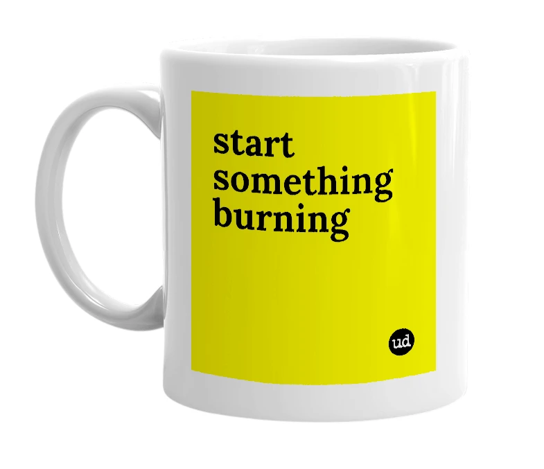 White mug with 'start something burning' in bold black letters