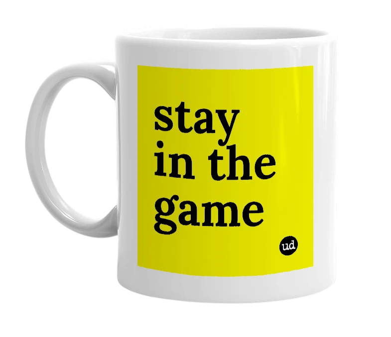 White mug with 'stay in the game' in bold black letters