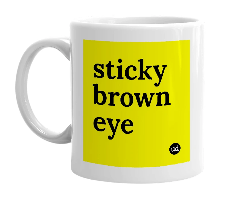 White mug with 'sticky brown eye' in bold black letters