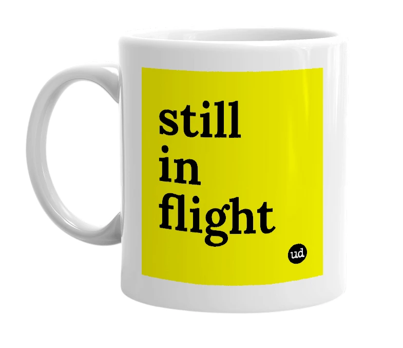 White mug with 'still in flight' in bold black letters