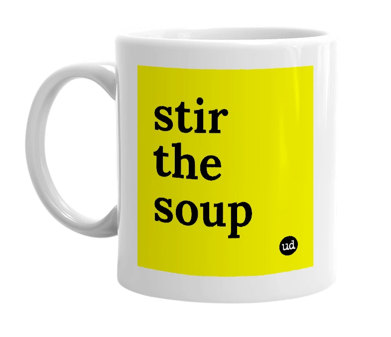 White mug with 'stir the soup' in bold black letters