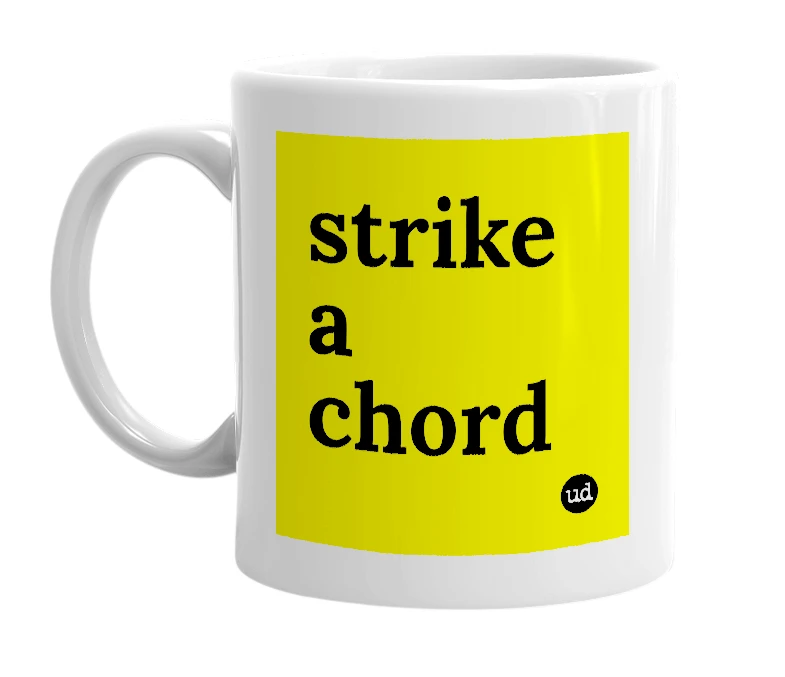 White mug with 'strike a chord' in bold black letters