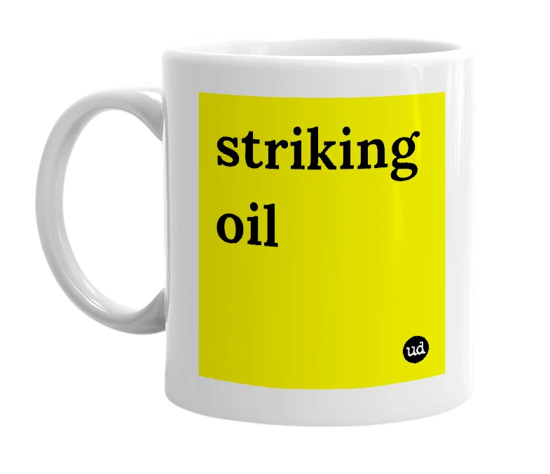 White mug with 'striking oil' in bold black letters