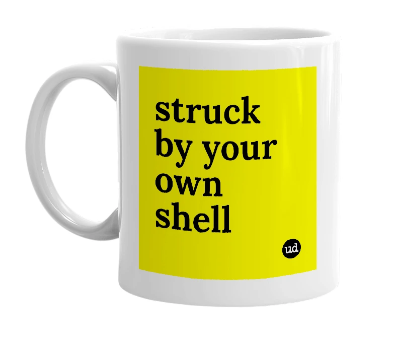 White mug with 'struck by your own shell' in bold black letters