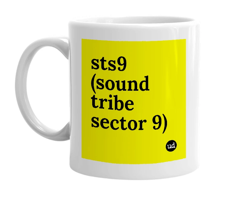 White mug with 'sts9 (sound tribe sector 9)' in bold black letters