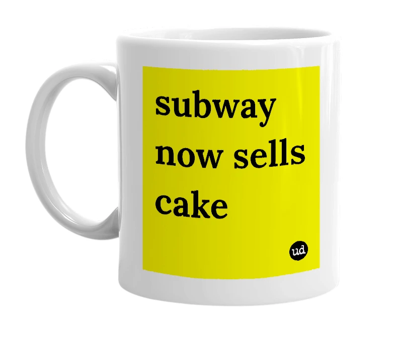 White mug with 'subway now sells cake' in bold black letters