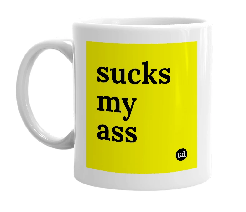 White mug with 'sucks my ass' in bold black letters