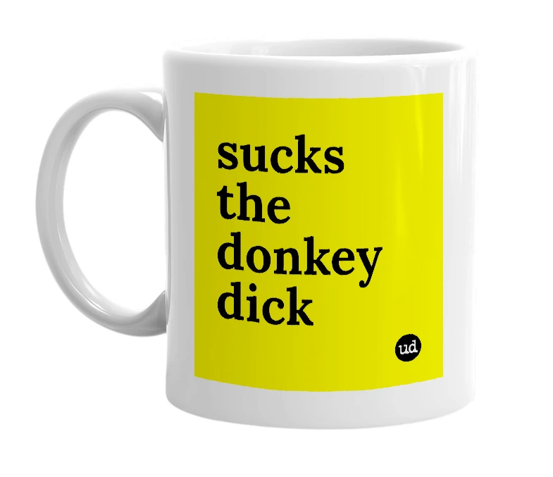 White mug with 'sucks the donkey dick' in bold black letters