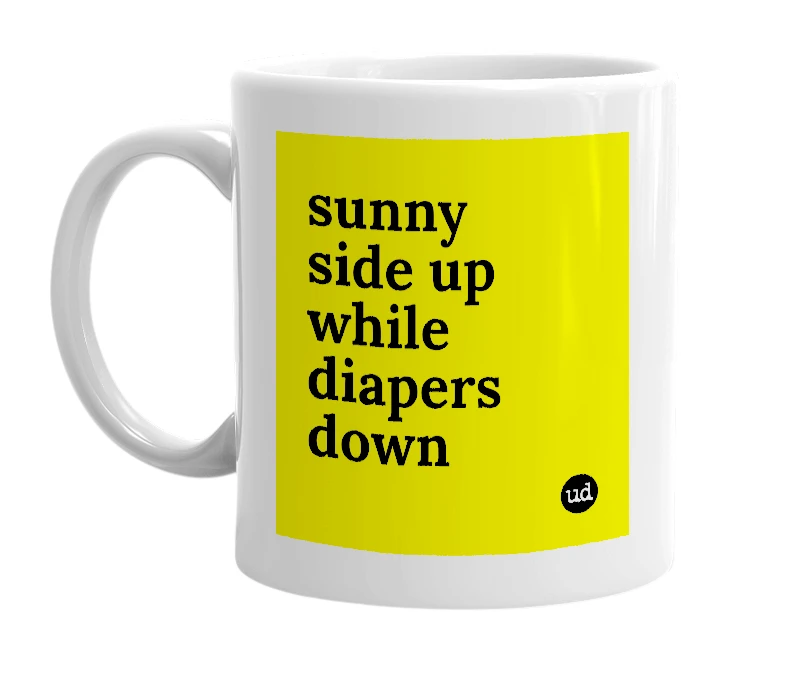 White mug with 'sunny side up while diapers down' in bold black letters