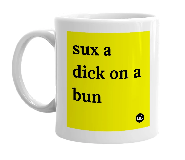 White mug with 'sux a dick on a bun' in bold black letters