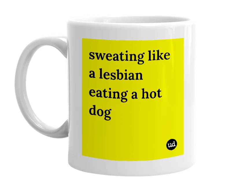 White mug with 'sweating like a lesbian eating a hot dog' in bold black letters