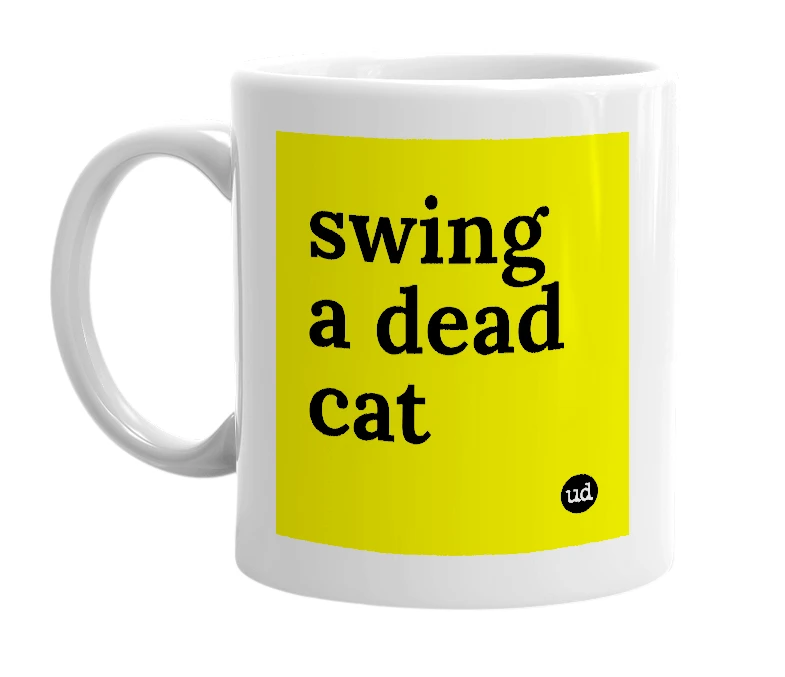 White mug with 'swing a dead cat' in bold black letters