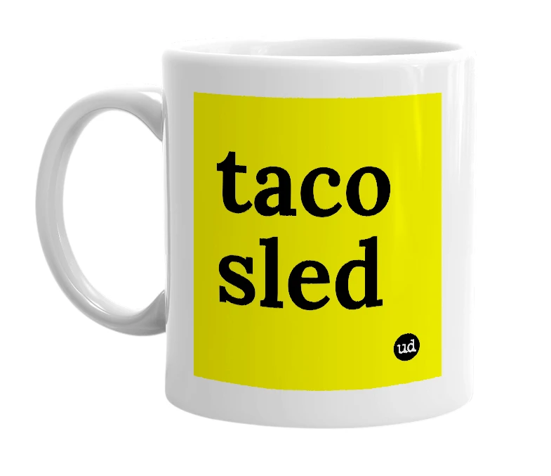 White mug with 'taco sled' in bold black letters