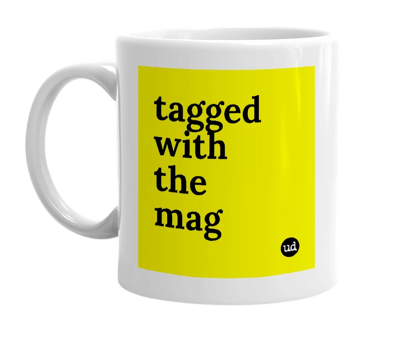 White mug with 'tagged with the mag' in bold black letters